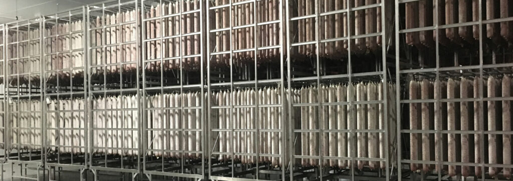Italian slicing salami in a drying room, featured in HUKKI VFX caliber 80 dry sausage casings.